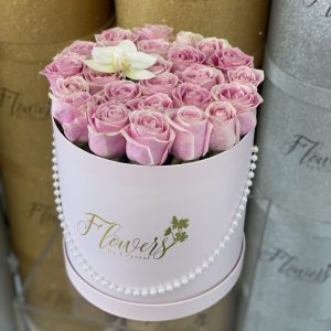 Pink Roses in pink round box with an orchid